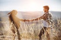 Young beautiful couple walking outside on beautiful sunset. Perfect romantic landscape for lovestory. Royalty Free Stock Photo