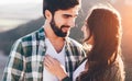 Young beautiful couple walking outside on beautiful sunset. Royalty Free Stock Photo