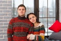 Young beautiful couple in warm knitted sweaters looking at the c Royalty Free Stock Photo