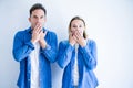 Young beautiful couple wearing denim shirt standing over isolated white background shocked covering mouth with hands for mistake Royalty Free Stock Photo