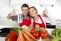 Young beautiful couple working at home kitchen preparing vegetable salad together smiling happy Royalty Free Stock Photo