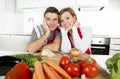 Young beautiful couple working at home kitchen preparing vegetable salad together smiling happy Royalty Free Stock Photo