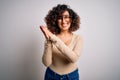 Young beautiful curly arab woman wearing casual t-shirt and glasses over white background clapping and applauding happy and Royalty Free Stock Photo