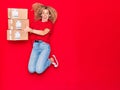 Young beautiful curly deliverywoman holding package smiling happy Royalty Free Stock Photo