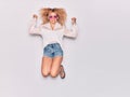 Young beautiful curly girl wearing casual clothes and retro sunglasses smiling happy Royalty Free Stock Photo