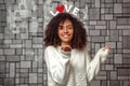 A young beautiful curly haired girl with a rim with the inscription love on her head sends a kiss through the air .Emotions and Royalty Free Stock Photo