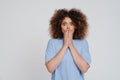 Young beautiful curly scared woman covering her mouth both hands Royalty Free Stock Photo