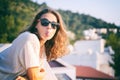 Young beautiful curly woman in sunglasses enjoying life summer sunshine showing tongue at the camera and teasing Royalty Free Stock Photo