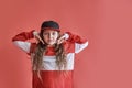 Young beautiful cute girl dancing on red background, modern slim hip-hop style teenage girl jumping Royalty Free Stock Photo