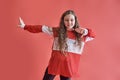 Young beautiful cute girl dancing on red background, modern slim hip-hop style teenage girl jumping Royalty Free Stock Photo