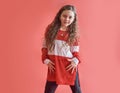 Young beautiful cute girl dancing on red background, modern slim hip-hop style teenage girl jumping Royalty Free Stock Photo