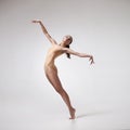 Young beautiful dancer in beige swimsuit