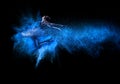 Young beautiful dancer jumping into blue powder cloud Royalty Free Stock Photo