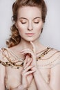 Young beautiful dark blonde woman in a gold necklace Royalty Free Stock Photo