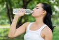 Young beautiful dark-haired woman wearing t-shirt drinking water Royalty Free Stock Photo