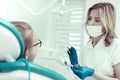 Young beautiful dentist holding necessary dental tools