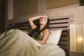 Young beautiful depressed and sad Asian Chinese woman having insomnia lying in bed at night sleepless suffering anxiety stress and Royalty Free Stock Photo