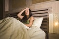 Young beautiful depressed and sad Asian Chinese woman having insomnia lying in bed at night sleepless suffering anxiety stress and Royalty Free Stock Photo