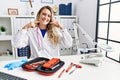 Young beautiful doctor woman with reflex hammer and medical instruments smiling cheerful showing and pointing with fingers teeth Royalty Free Stock Photo