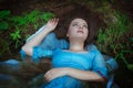 Young beautiful drowned woman lying in the water