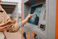 Young beautiful elegant blonde woman paying for service underground parking or buying a subway or train ticket using an Royalty Free Stock Photo