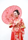 Young, beautiful and elegant Chinese woman wearing a typical Chinese bride`s silk red dress, adorned with golden phoenix and drago Royalty Free Stock Photo