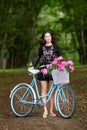 Young beautiful, elegantly dressed woman with retro bicycle. Healthy, cycling.