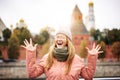 Young beautiful enthusiastic expressive woman in glasses traveler in the historical center of Moscow russia on an autumn day