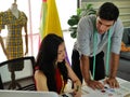 THe young beautiful European fasign designer and handsome co worker selecting the color sample