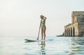 Young beautiful european woman tourist practicing paddle boarding, Alanya, Turkey