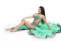 Young beautiful exotic eastern women in ethnic green dress. Isolated on white background Royalty Free Stock Photo