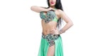 Young beautiful exotic eastern women performs belly dance in ethnic green dress. Isolated on white background Royalty Free Stock Photo