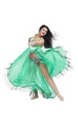 Young beautiful exotic eastern women performs belly dance in ethnic green dress. Isolated on white background Royalty Free Stock Photo