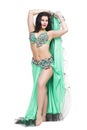 Young beautiful exotic eastern women performs belly dance in ethnic green dress. Isolated on white background Royalty Free Stock Photo