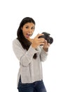 Young beautiful exotic hispanic photographer woman smiling happy looking reflex camera Royalty Free Stock Photo