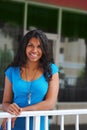 Young beautiful exotic woman smiling from balcony Royalty Free Stock Photo