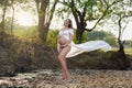 Young beautiful expecting mother standing holding maternity belly