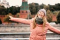 Young beautiful expressive woman in glasses traveler in the historical center of Moscow, travel to Russia