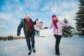 Young beautiful family in bright clothes winter fun jumping and running, snow, lifestyle, winter holidays