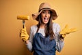 Young beautiful farmer woman wearing apron and hat holding fork with cob corn very happy and excited, winner expression Royalty Free Stock Photo