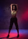 Young beautiful fashion Asian girl dancer in studio with neon lights Royalty Free Stock Photo