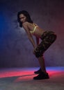 Young beautiful fashion Asian girl dancer in studio with neon lights