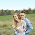 Pretty nice young couple eating ice cream outdoors. Royalty Free Stock Photo