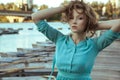 Young beautiful fashion model posing on pier. Royalty Free Stock Photo