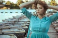 Young beautiful fashion model posing on pier. Royalty Free Stock Photo