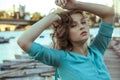 Young beautiful fashion model posing on pier. Royalty Free Stock Photo