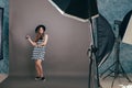 Young beautiful fashionable woman with trendy makeup in black hat and glasses on the grey background . Model looking at camera, w Royalty Free Stock Photo