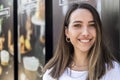 Young and beautiful female barista posing a smile