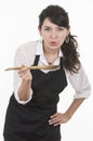 Young beautiful female chef wearing black apron