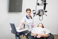 Young beautiful female dentist with woman patient preparing for treatment with microscope in dental clinic Royalty Free Stock Photo